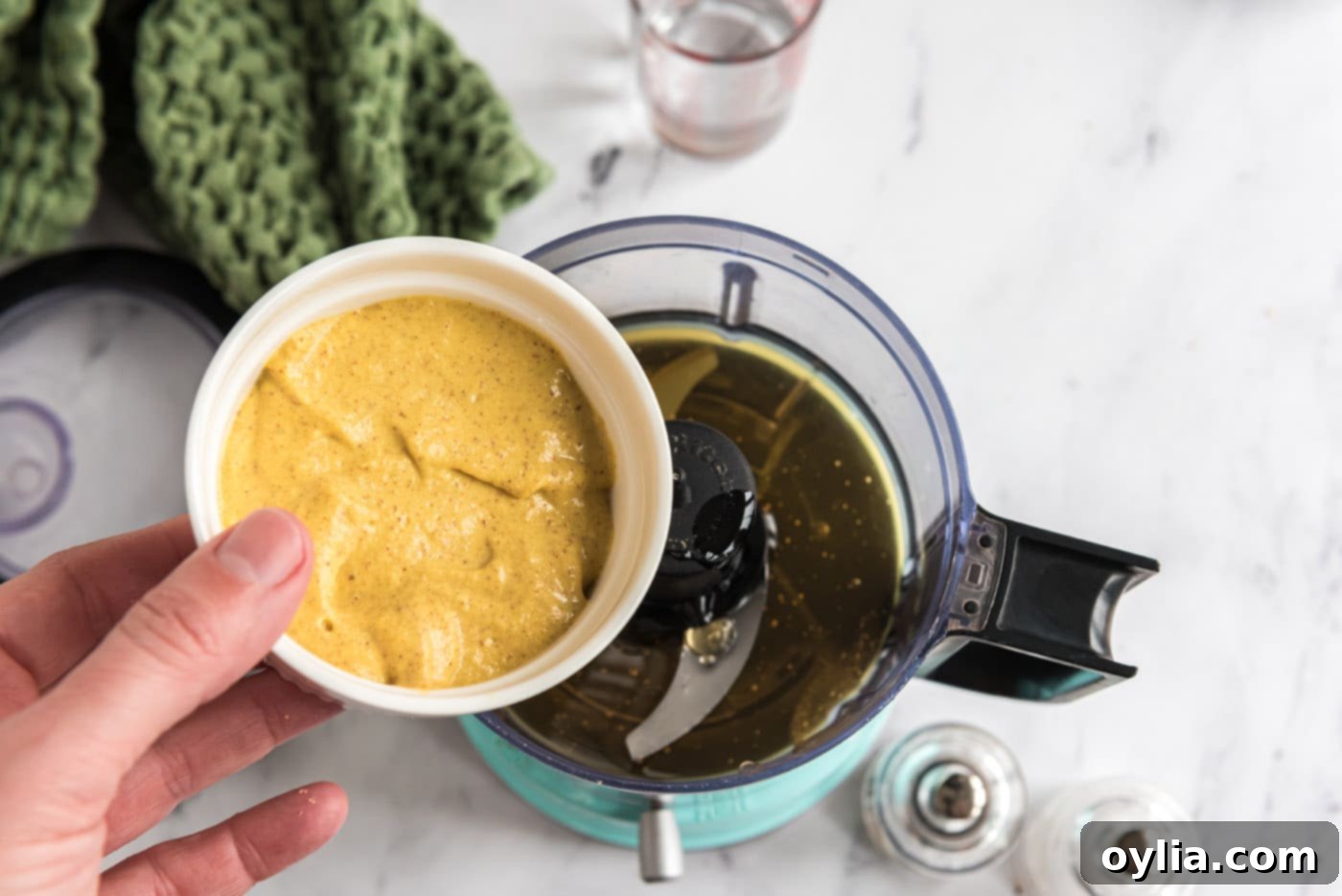 adding honey and mustard to food processor for dressing