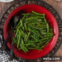 Vibrant Green Bean Sauté 10 Close up photo of Sautéed Green Beans on a red plate