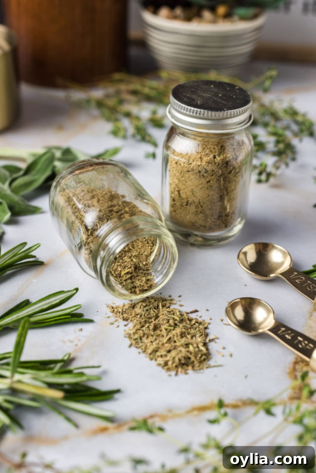 Jar of Poultry Seasoning tipped onto the counter with another jar of Poultry Seasoning behind it, showcasing the rich, earthy blend.