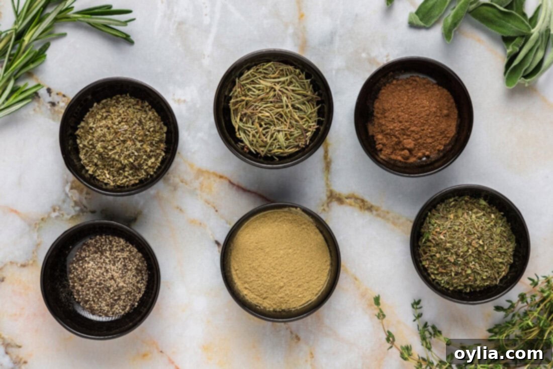 Individual bowls containing the dry ingredients for Poultry Seasoning: rosemary, marjoram, thyme, sage, nutmeg, and black pepper.