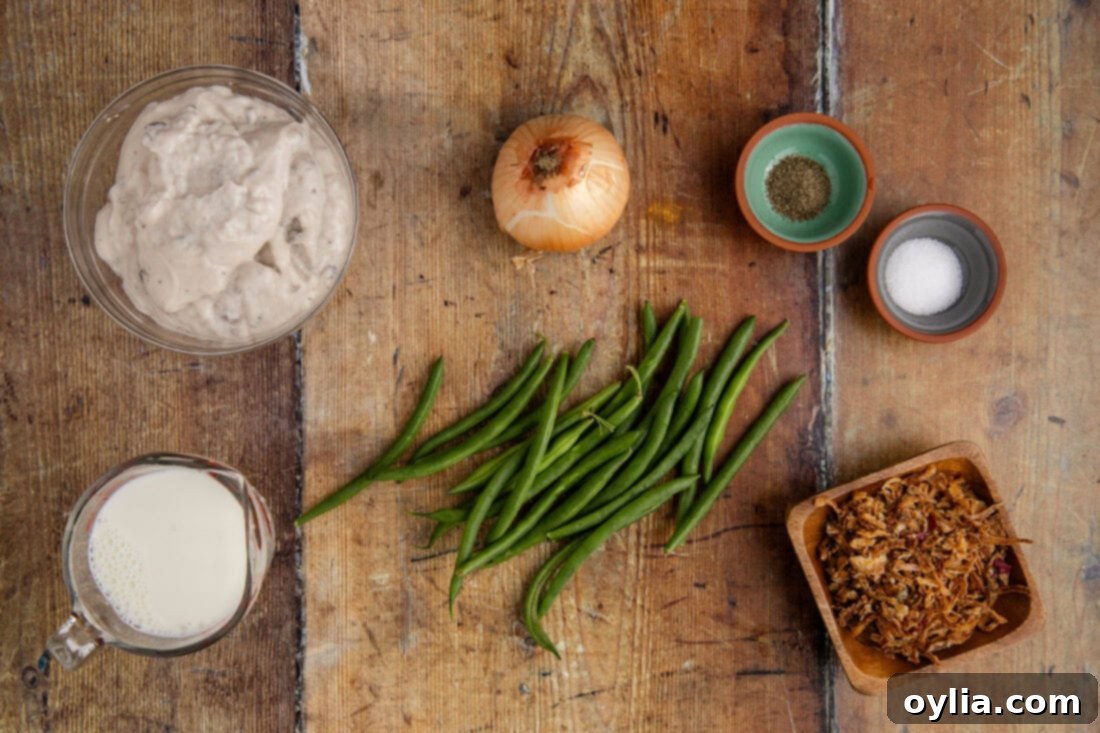 Arrangement of ingredients for Crockpot Green Bean Casserole including fresh green beans, cream of mushroom soup, milk, and French fried onions