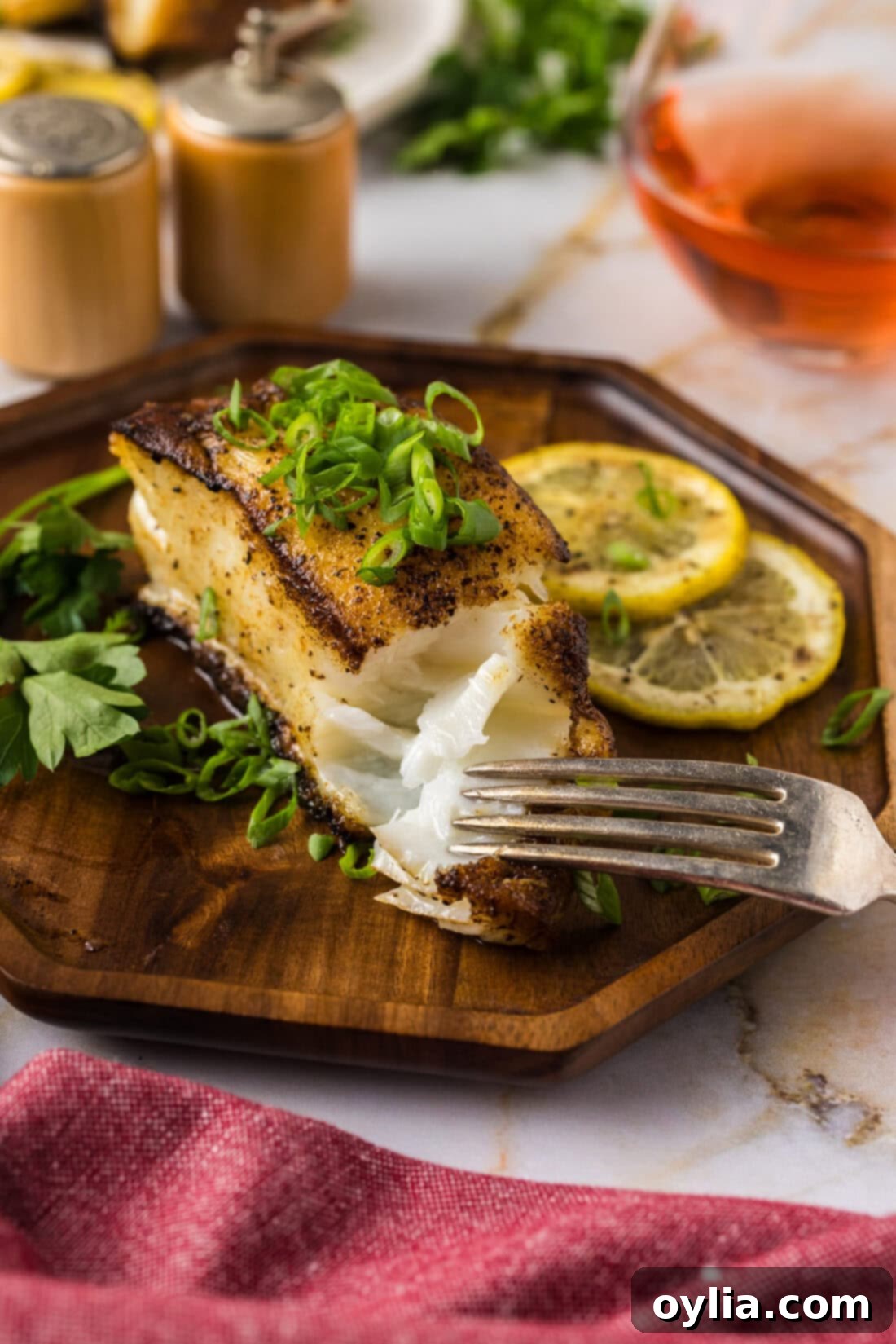 Perfectly Pan-Seared Chilean Sea Bass 2 Fork breaking apart a Pan Seared Chilean Sea Bass filet