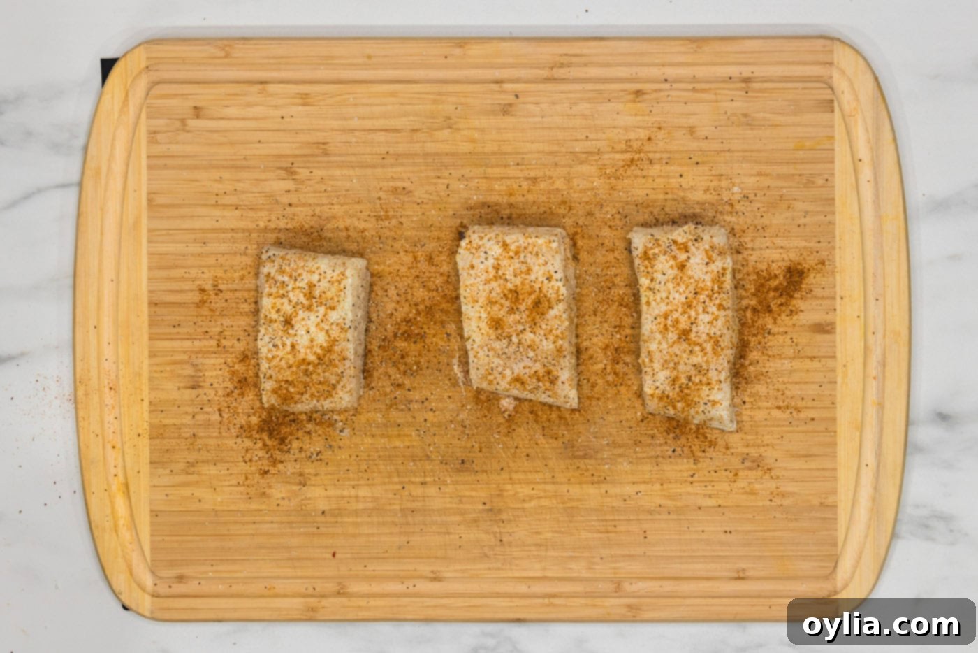 seasoned chilean sea bass filets on a cutting board