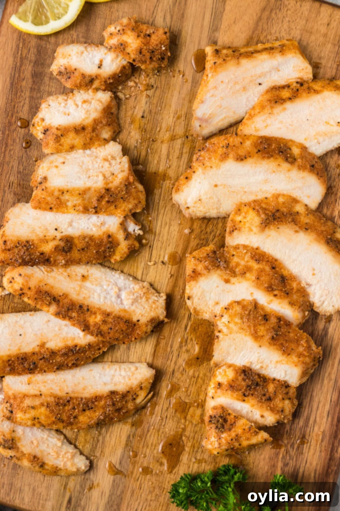 Close up photo of perfectly cooked, succulent slices of Sous Vide Chicken Breast on a wooden board