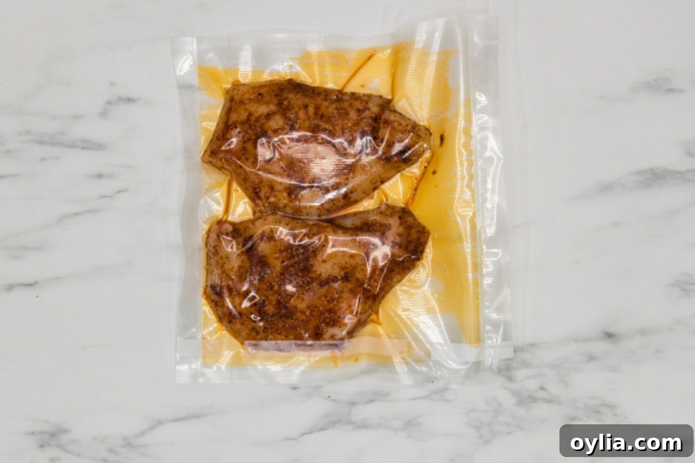 seasoned chicken breast perfectly sealed in a vacuum bag, ready for sous vide cooking