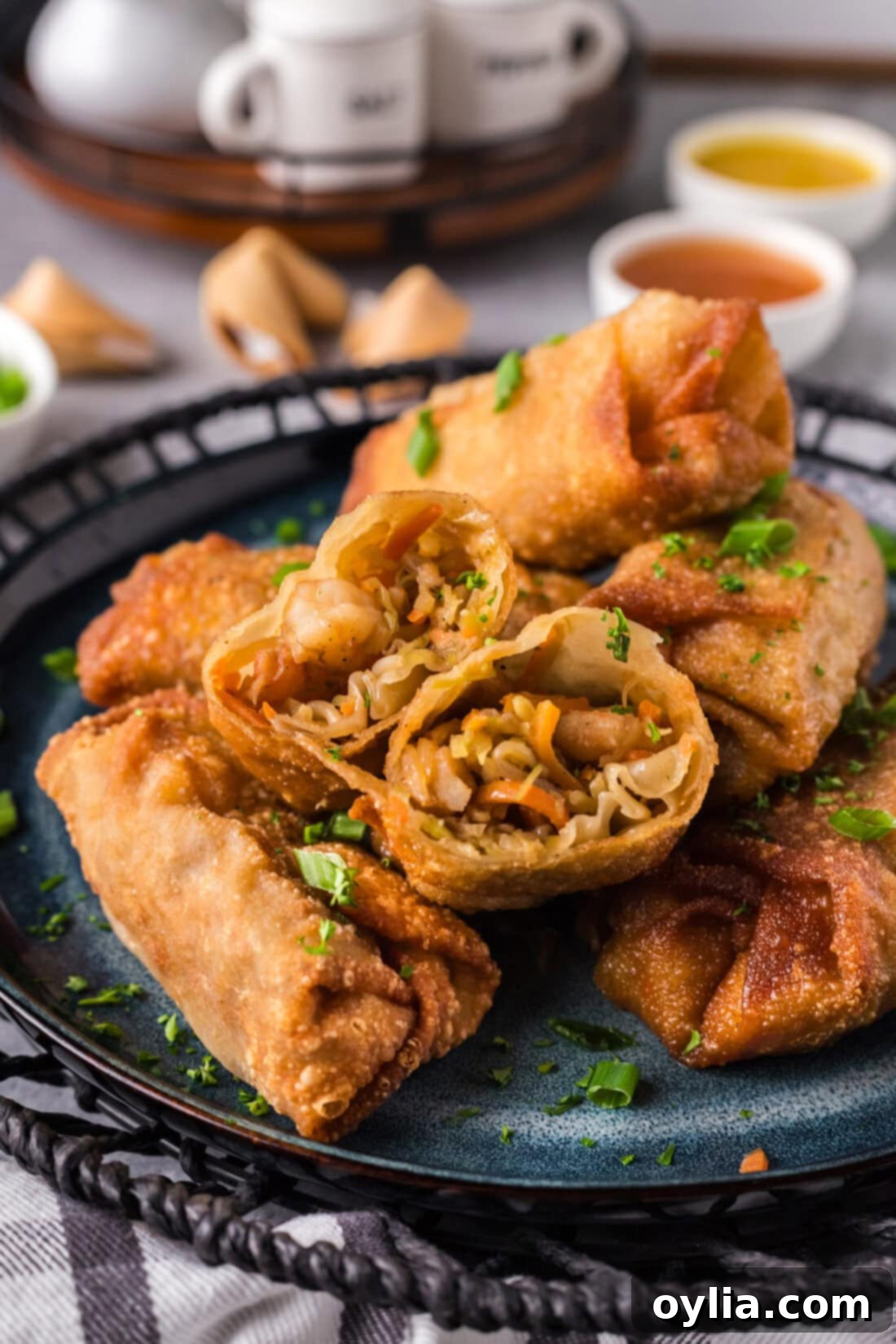 A delicious pile of golden-brown crispy homemade shrimp egg rolls, ready to be served