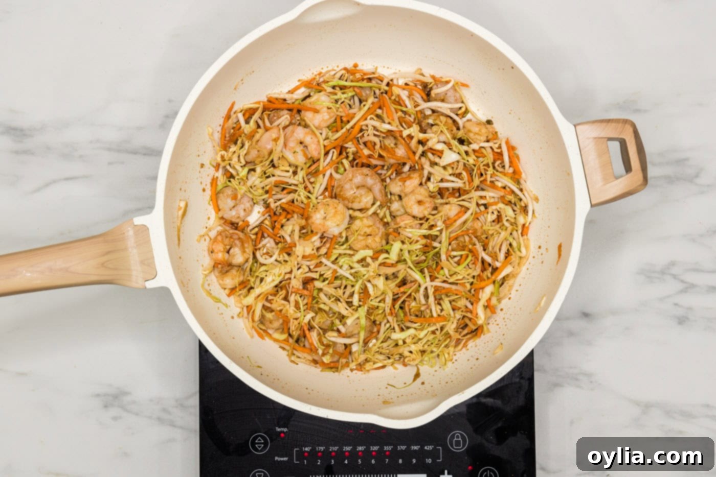 Close-up of the flavorful shrimp and vegetable egg roll filling simmering in a skillet