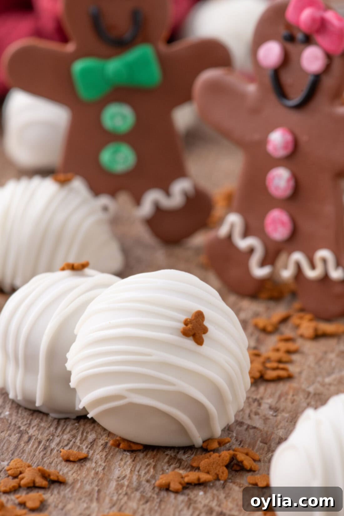 Gingerbread Dream Oreo Truffles 11 Close-up of a gingerbread Oreo truffle with a gingerbread cookie and festive background