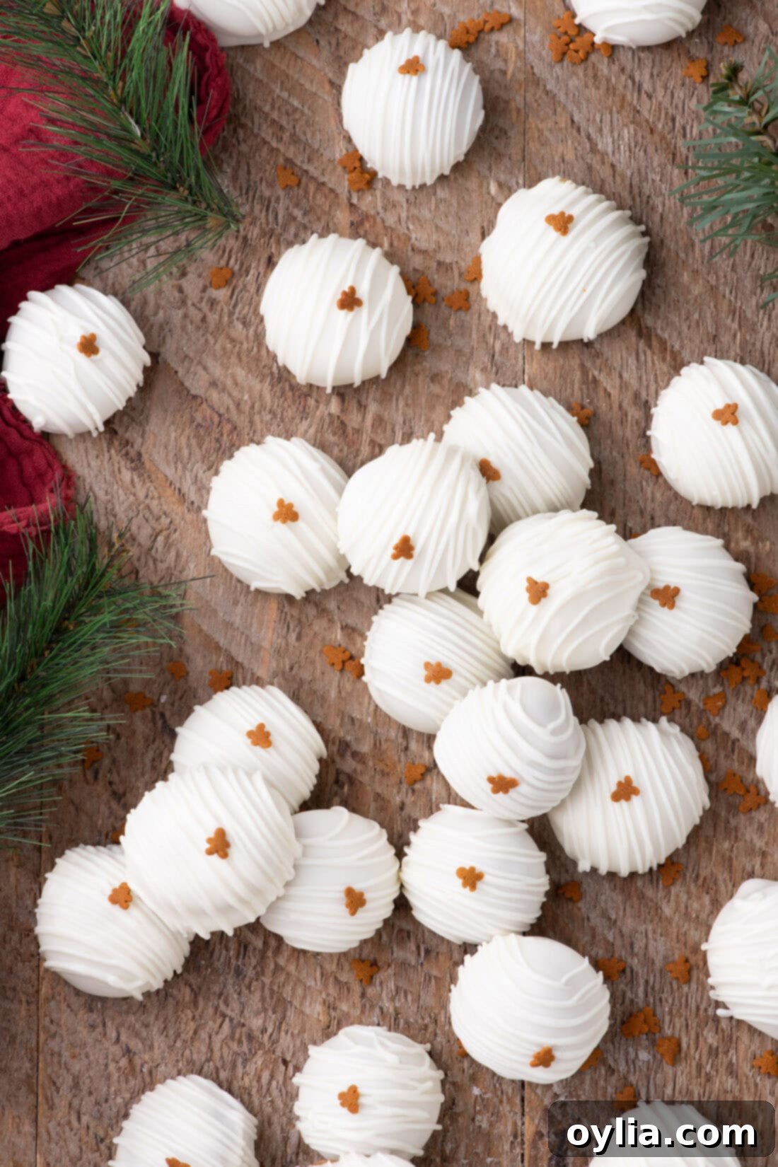 Gingerbread Dream Oreo Truffles 3 Gingerbread Oreo truffles resting on a rustic wood board with holiday decor