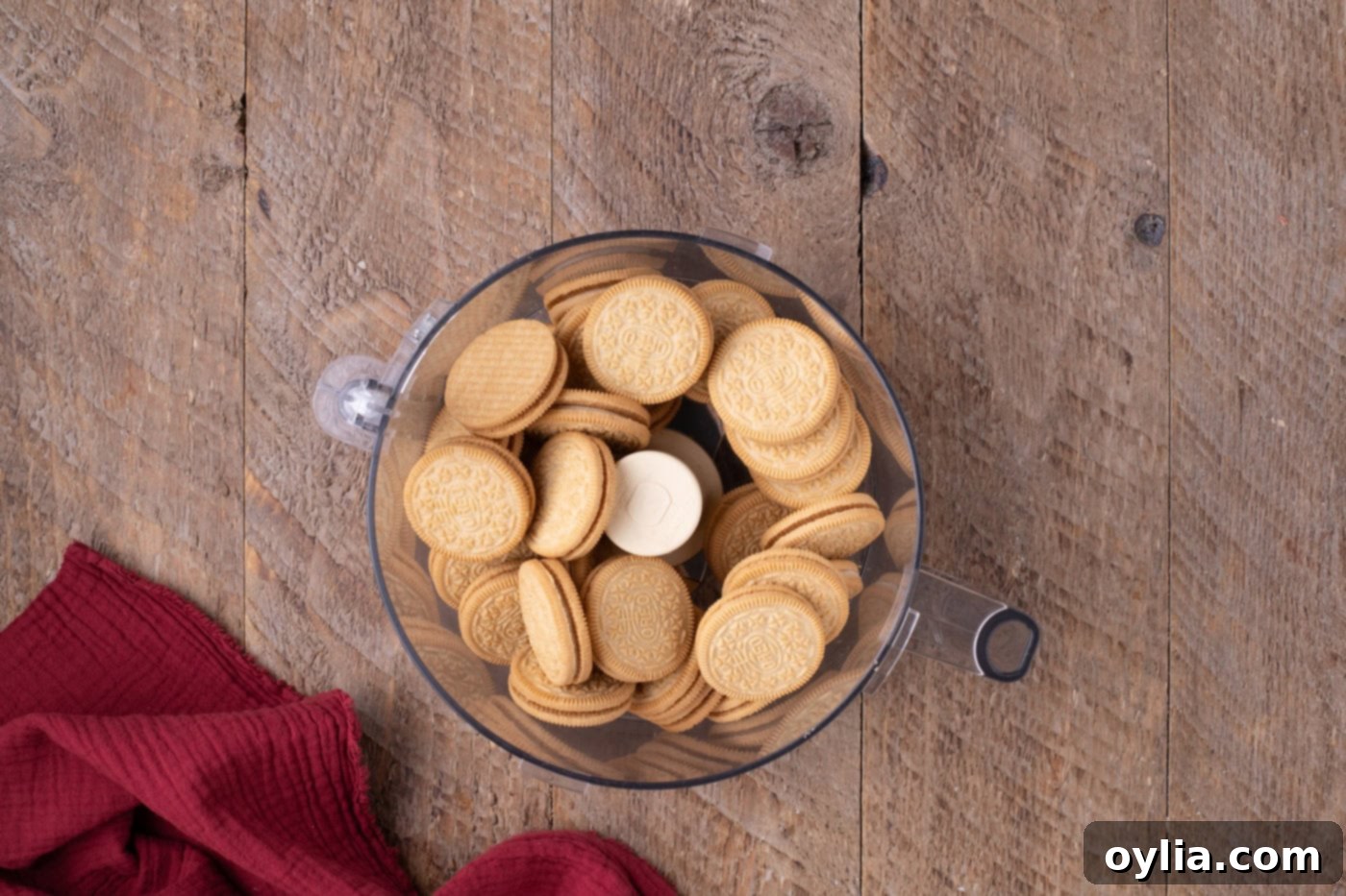 Golden Oreo cookies being crushed in a food processor