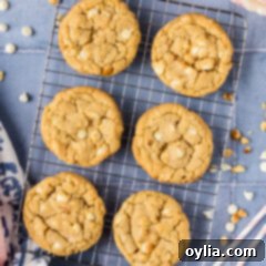 Close up photo of White Chocolate Macadamia Nut Cookies cooling on a wire rack, showcasing their irresistible texture.