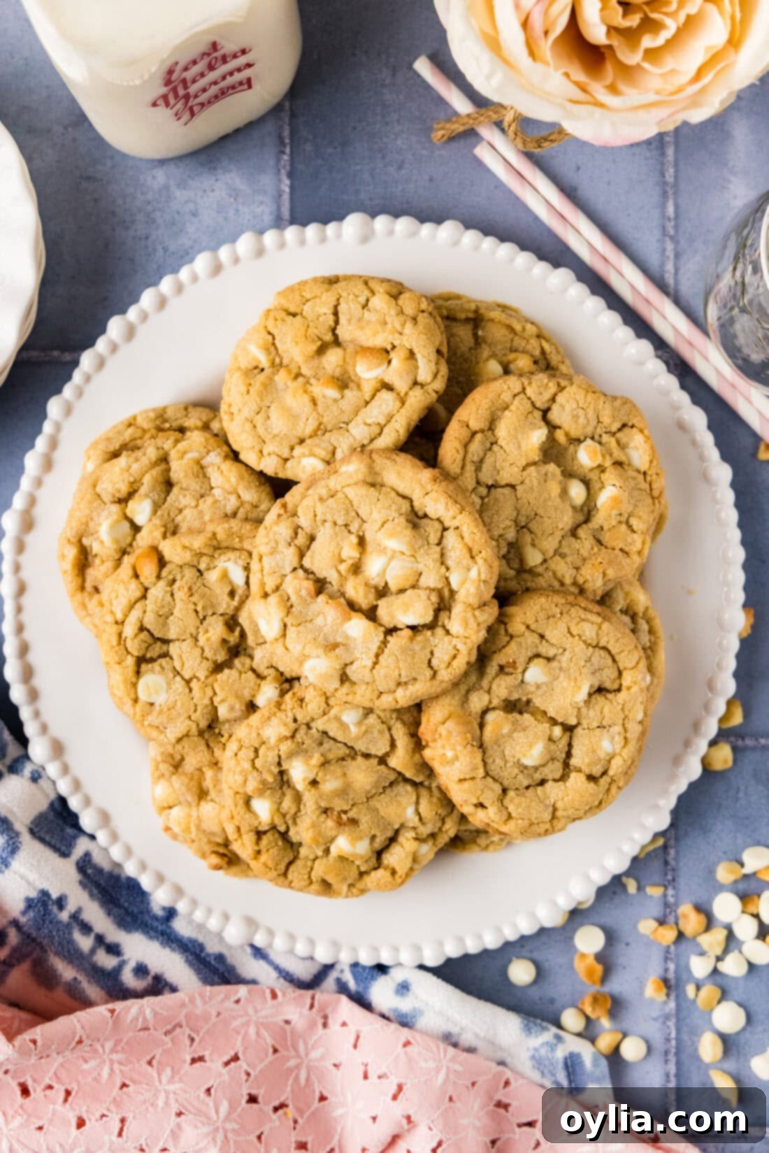 Plate of freshly baked White Chocolate Macadamia Nut Cookies, stacked appealingly.