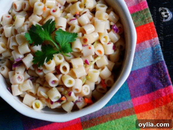 A close-up overhead shot of the simple and refreshing 3-ingredient quick pasta salad in a bowl, garnished with fresh parsley.