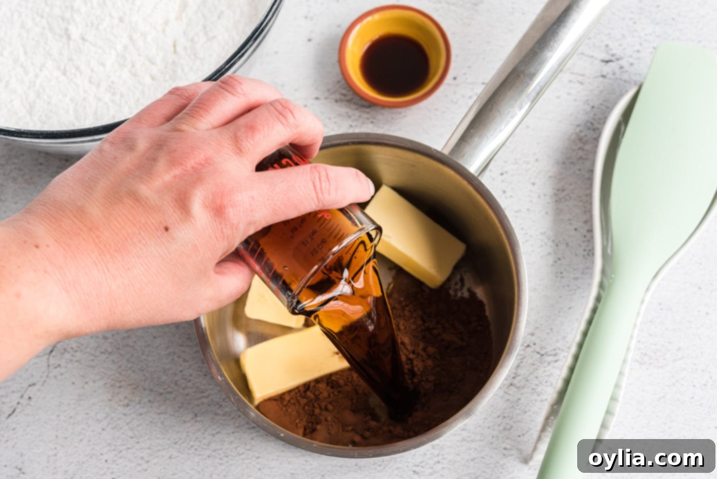 Coca-Cola, cocoa powder, and butter melting in a saucepan for the frosting