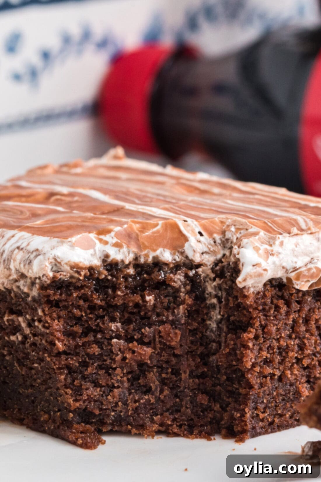 A slice of Cracker Barrel Coke Cake with a bite taken out, showing the layered texture