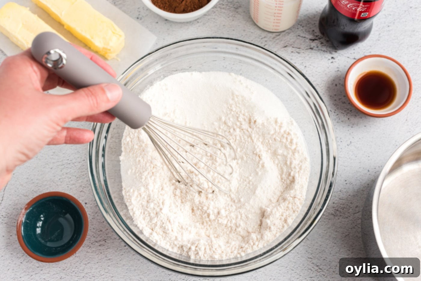 Dry ingredients for cake whisked together in a mixing bowl