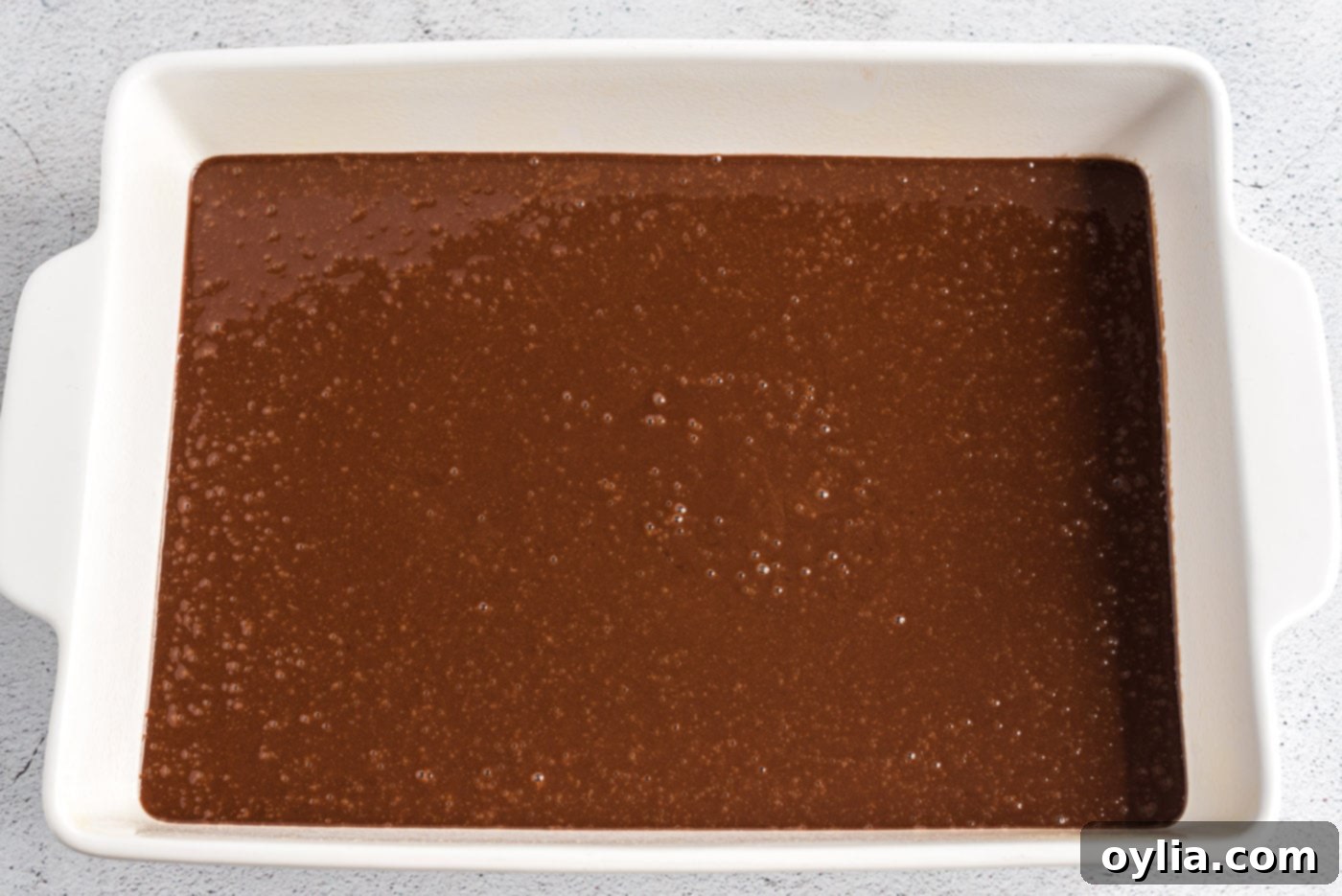 Coca-Cola cake batter poured into a baking dish, ready for the oven