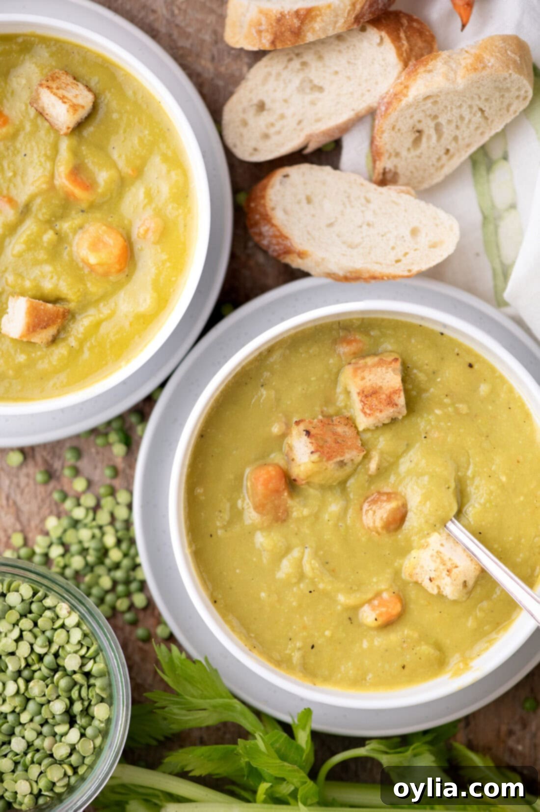Hearty Instant Pot Split Pea Soup 2 Two bowls of Instant Pot Split Pea Soup with bread on the side, showcasing a rich green color and hearty texture