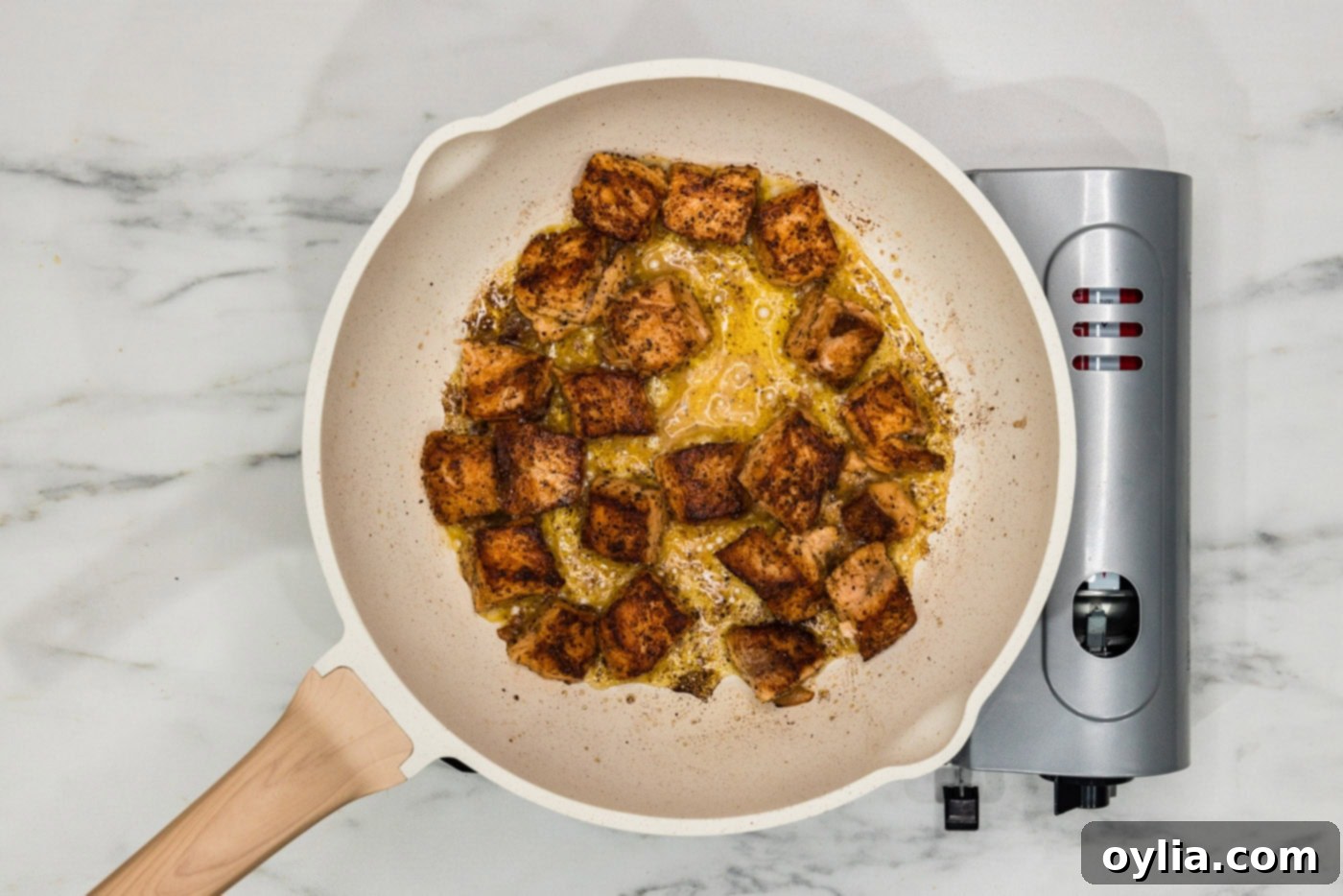 cooked salmon cubes in a skillet