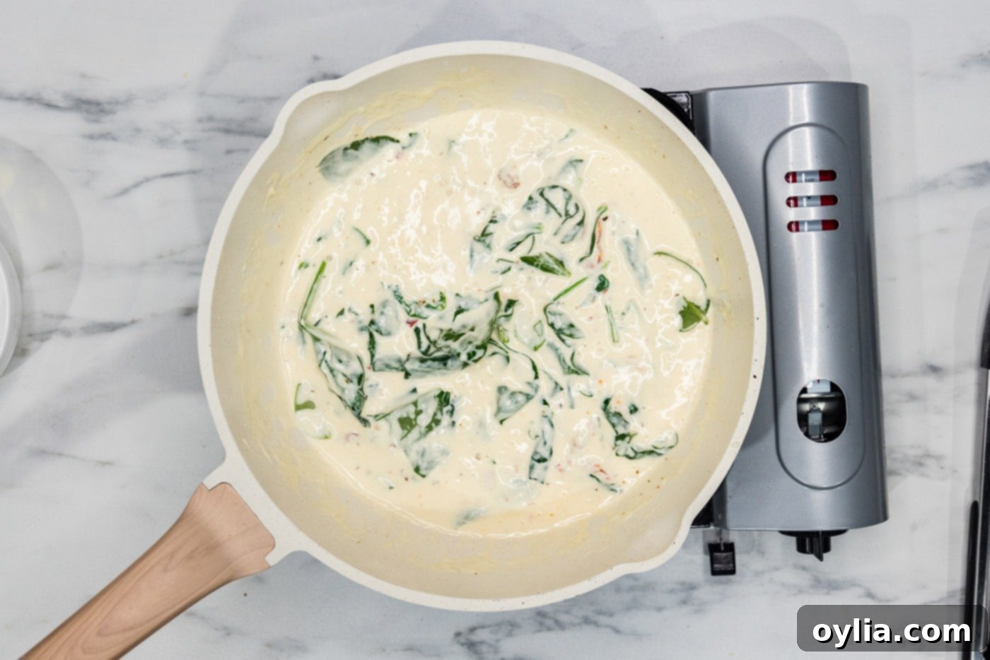 spinach in cream sauce in a skillet