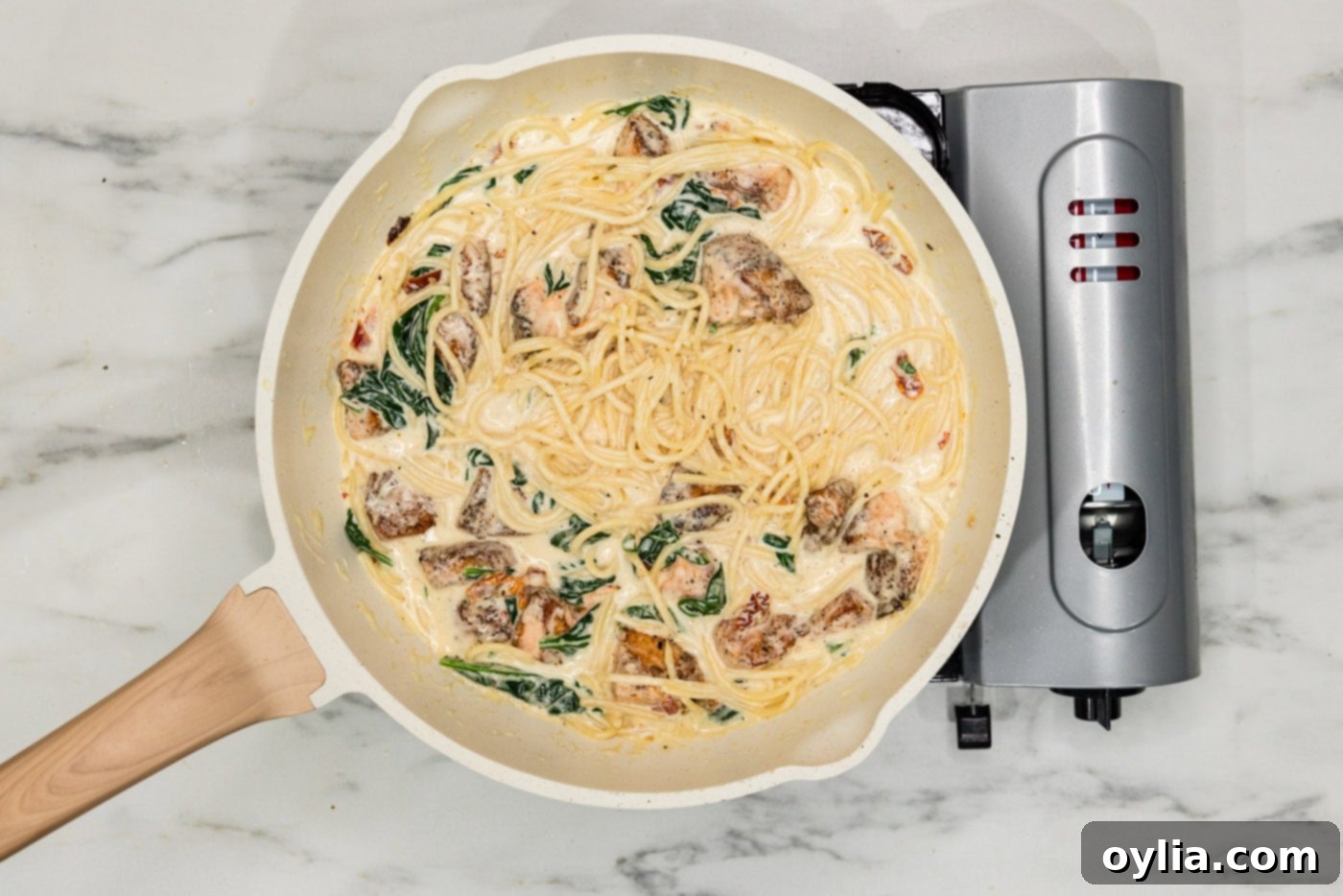salmon pasta in a skillet with cream sauce