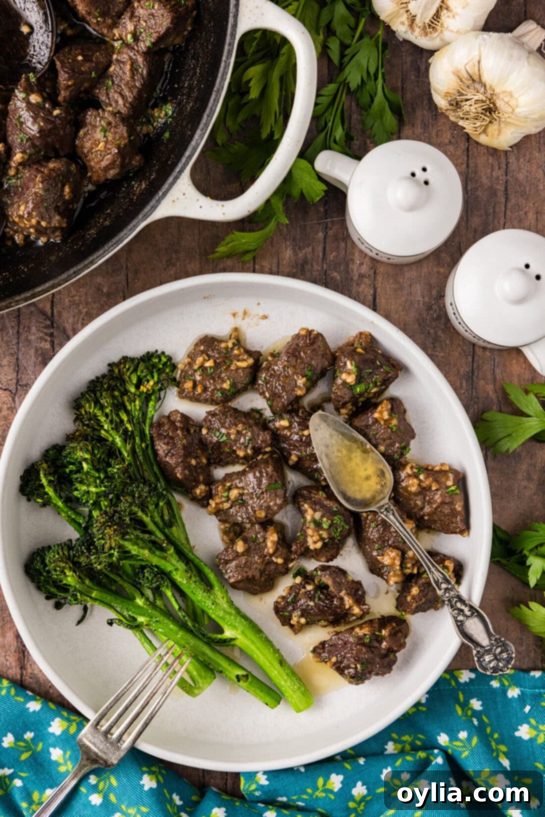 Garlic Butter Steak Bites on a plate with broccolini 