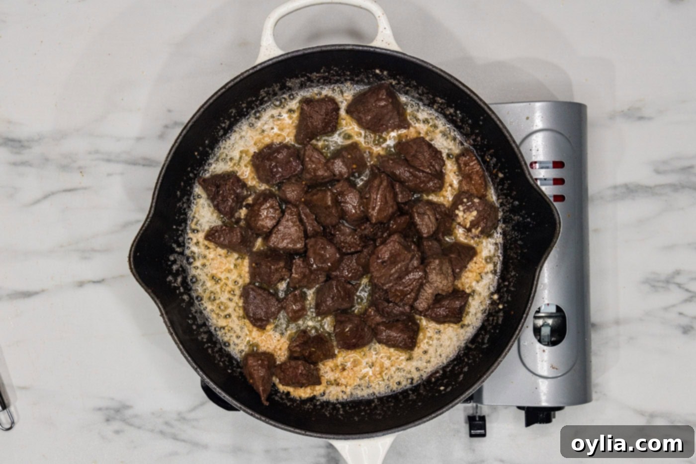 steak bites in a skillet with garlic utter