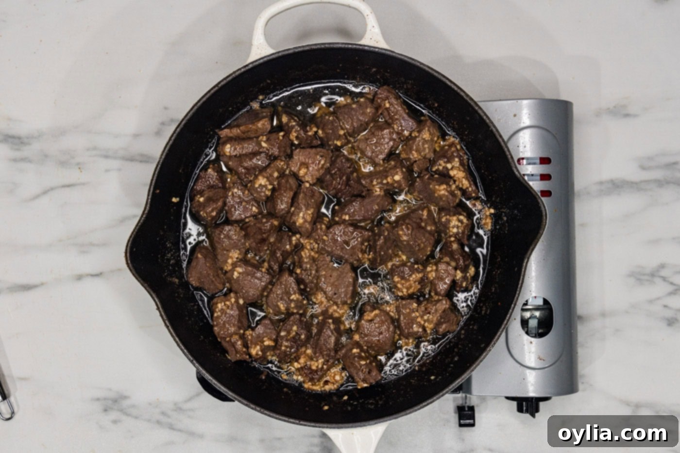 overhead of garlic butter steak bites in a skillet