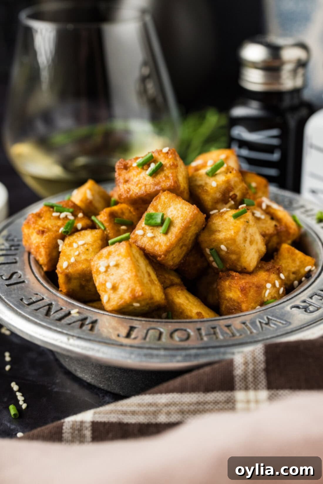Crispy golden deep-fried tofu cubes seasoned with umami soy sauce, served in an appetizer bowl, ready for stir-fries, grain bowls, or noodles.