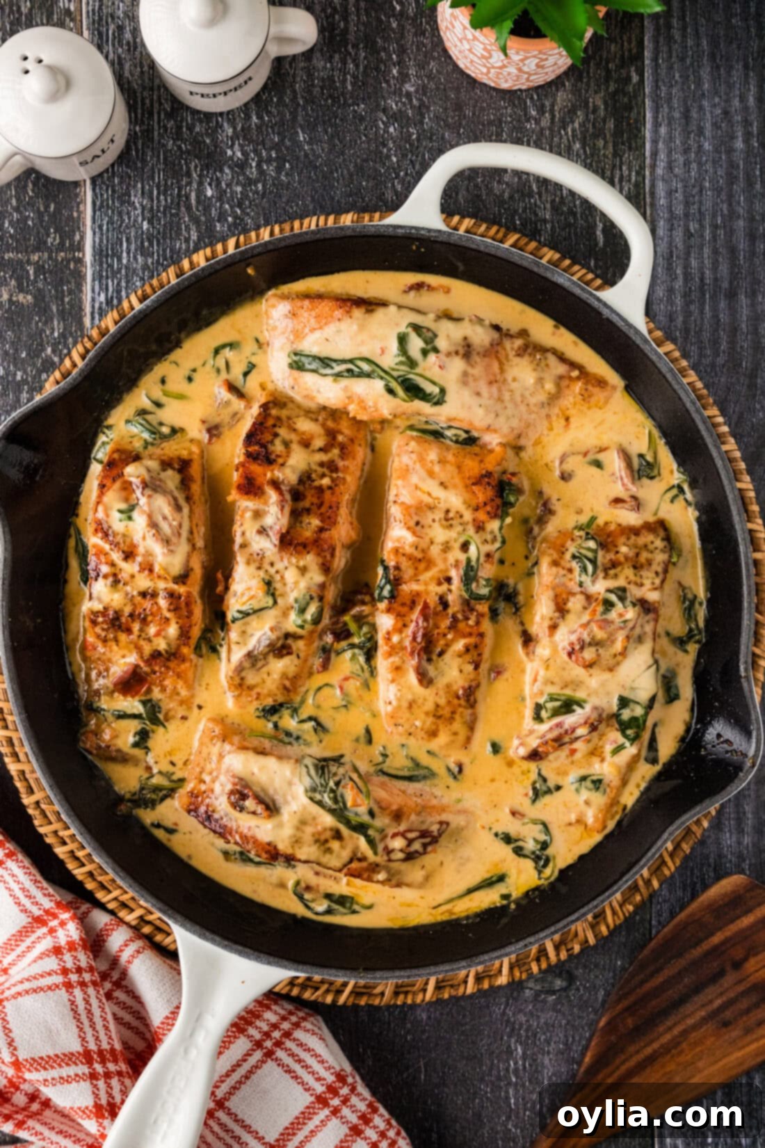 Velvety Salmon 11 Close-up of creamy salmon with sun-dried tomatoes and spinach in a skillet, ready to be served.