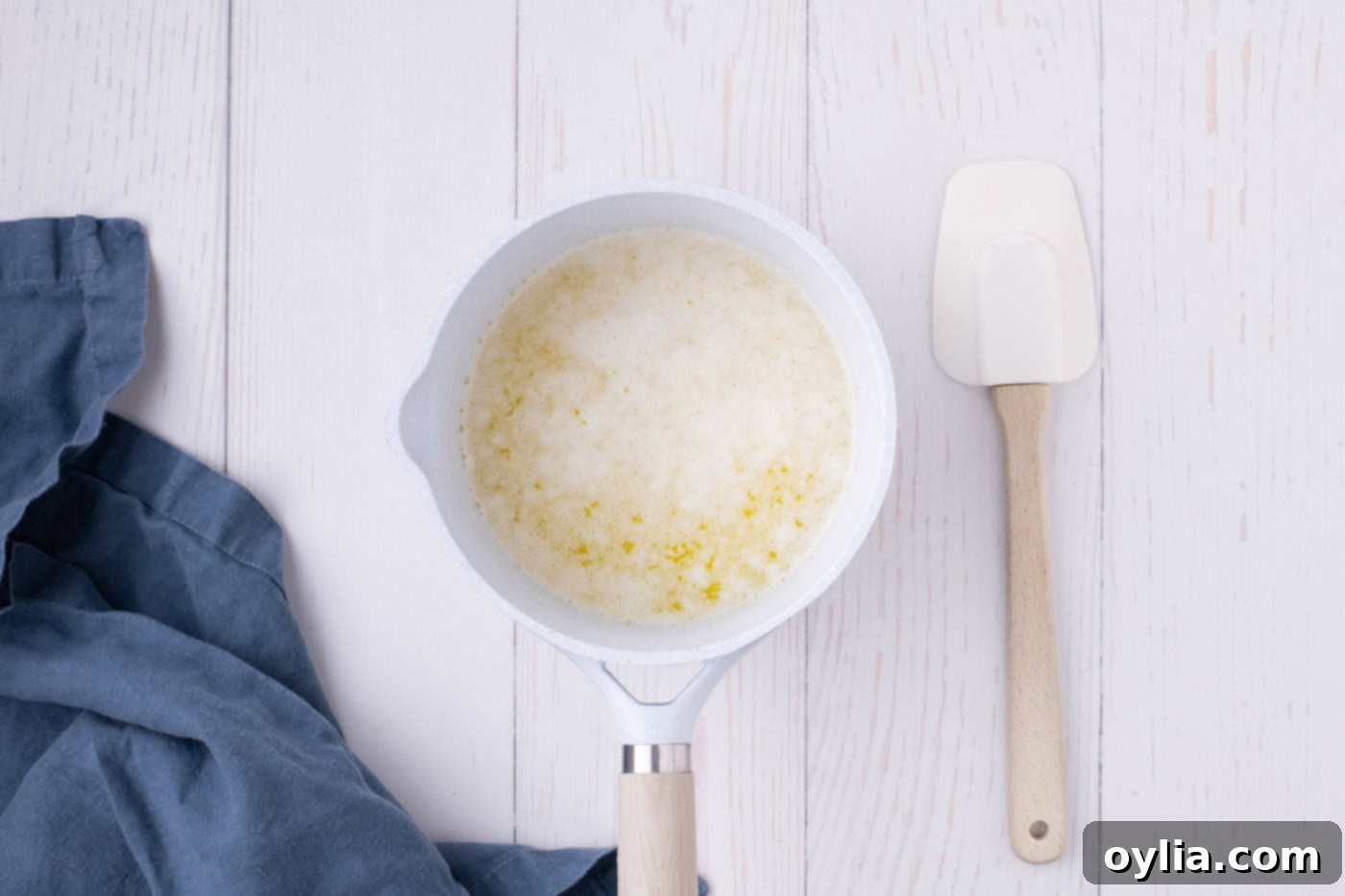 Unsalted butter foaming in a saucepan over medium heat, beginning the browning process