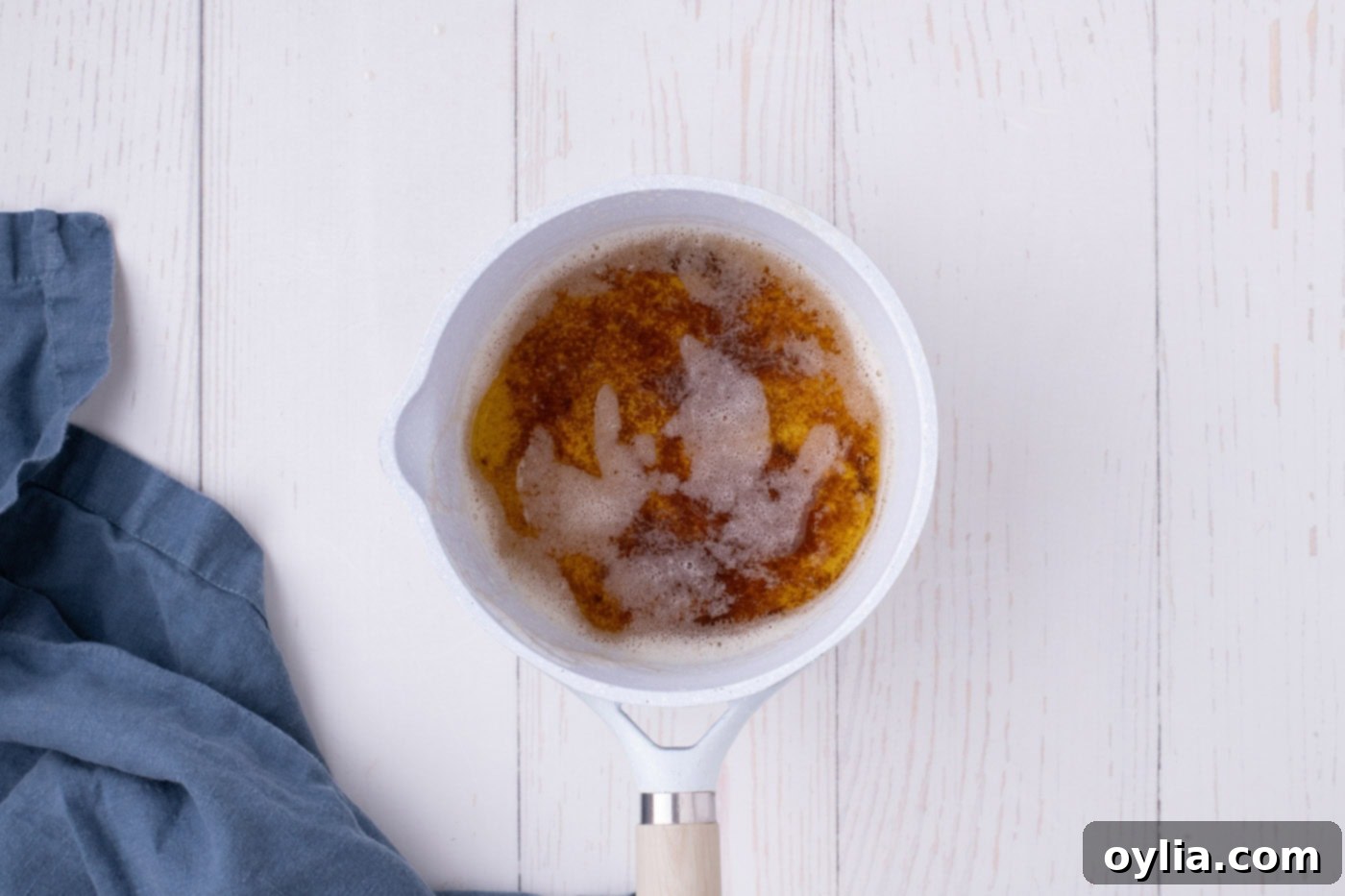 Perfectly browned butter in a saucepan with rich, nutty sediments at the bottom