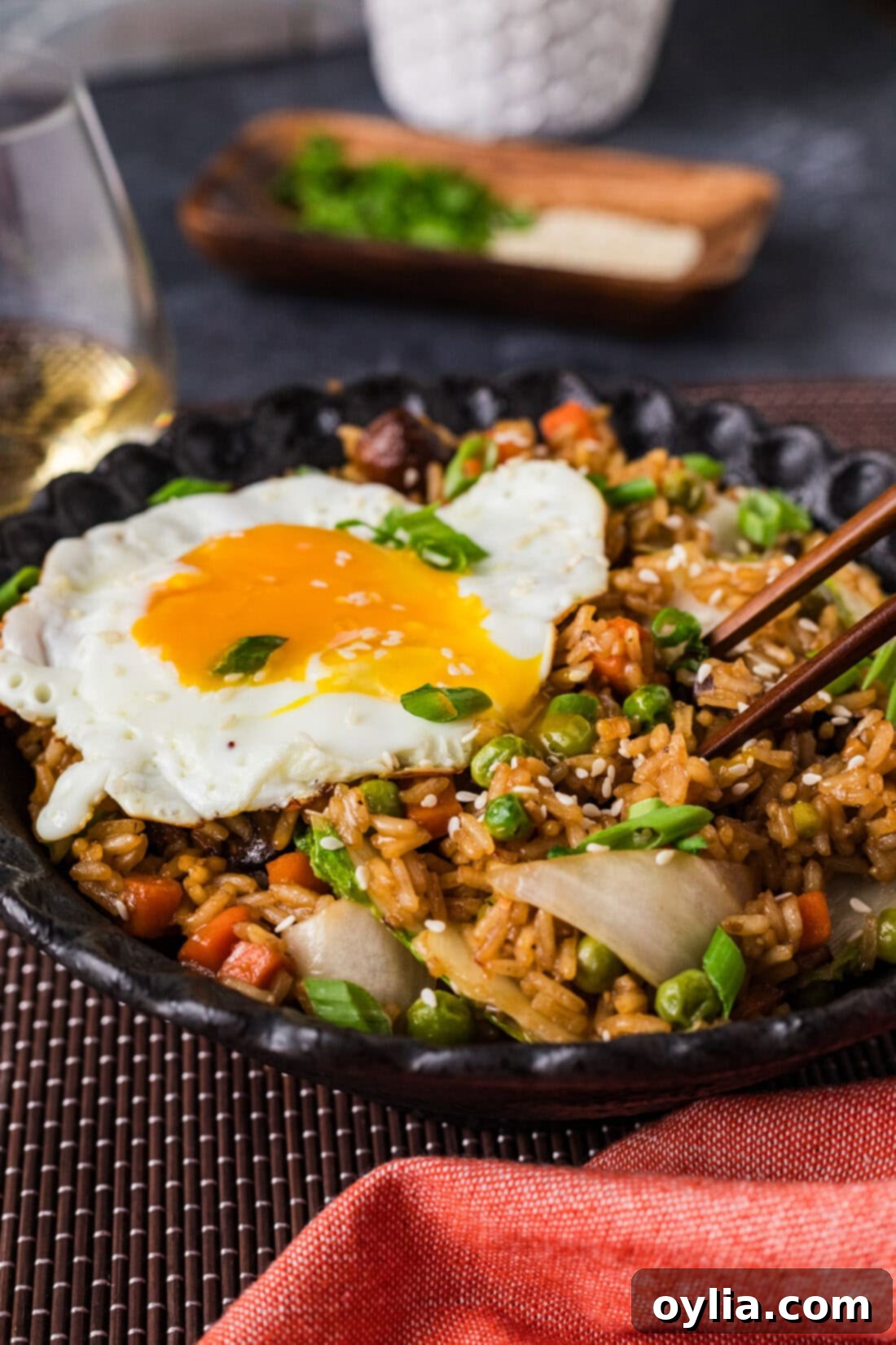 Bowl of Korean Fried Rice with chopsticks in it, ready to be enjoyed.