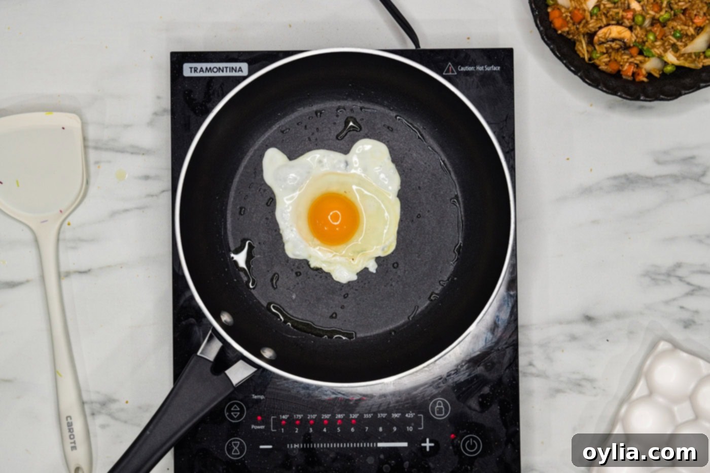 A perfectly cooked sunny-side-up egg in a skillet.