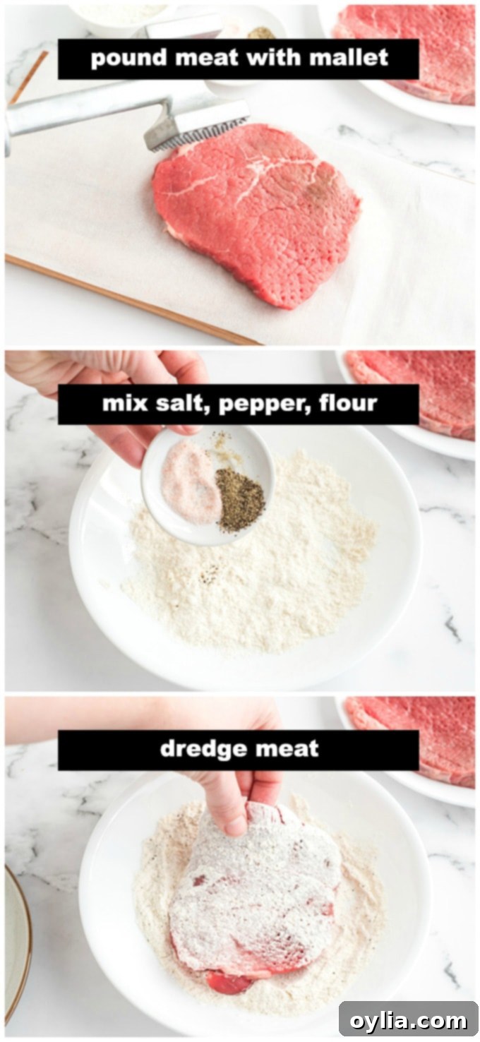 A hand dredging a piece of beef round steak in a seasoned flour mixture.