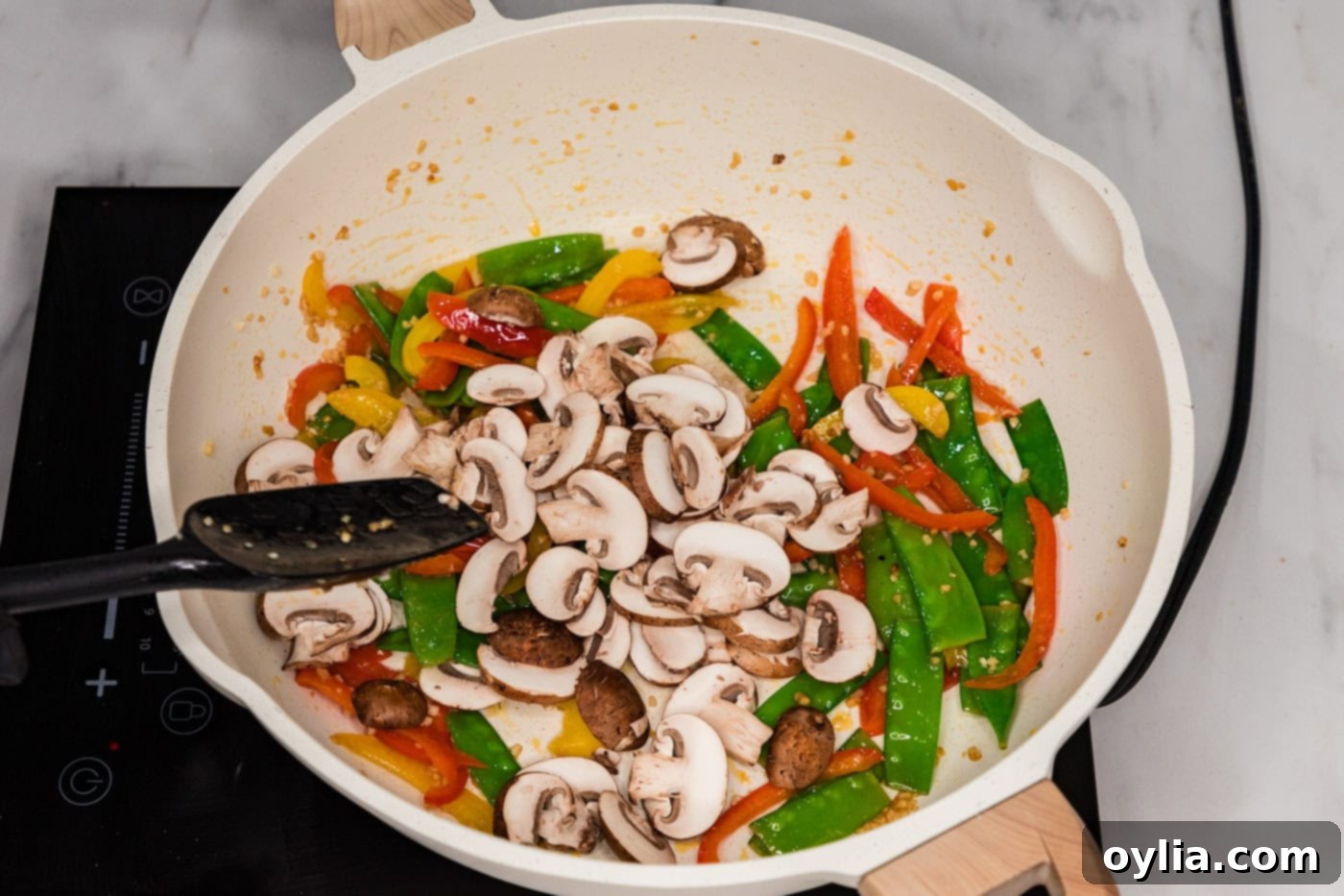 mushrooms, snow peas, and bell peppers in a skillet