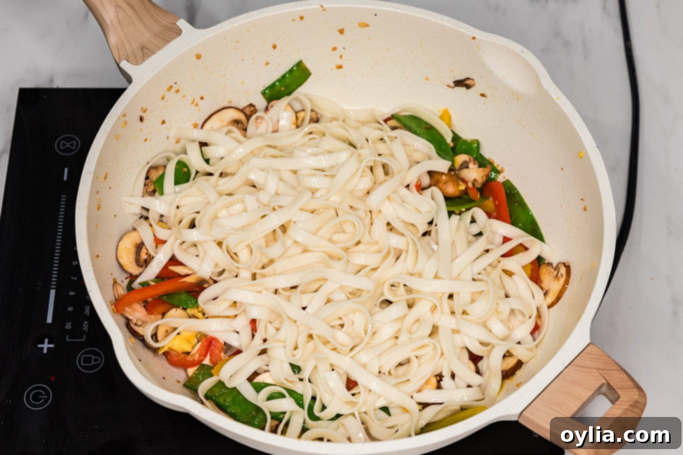 lo mein noodles added to skillet with stir fry veggies