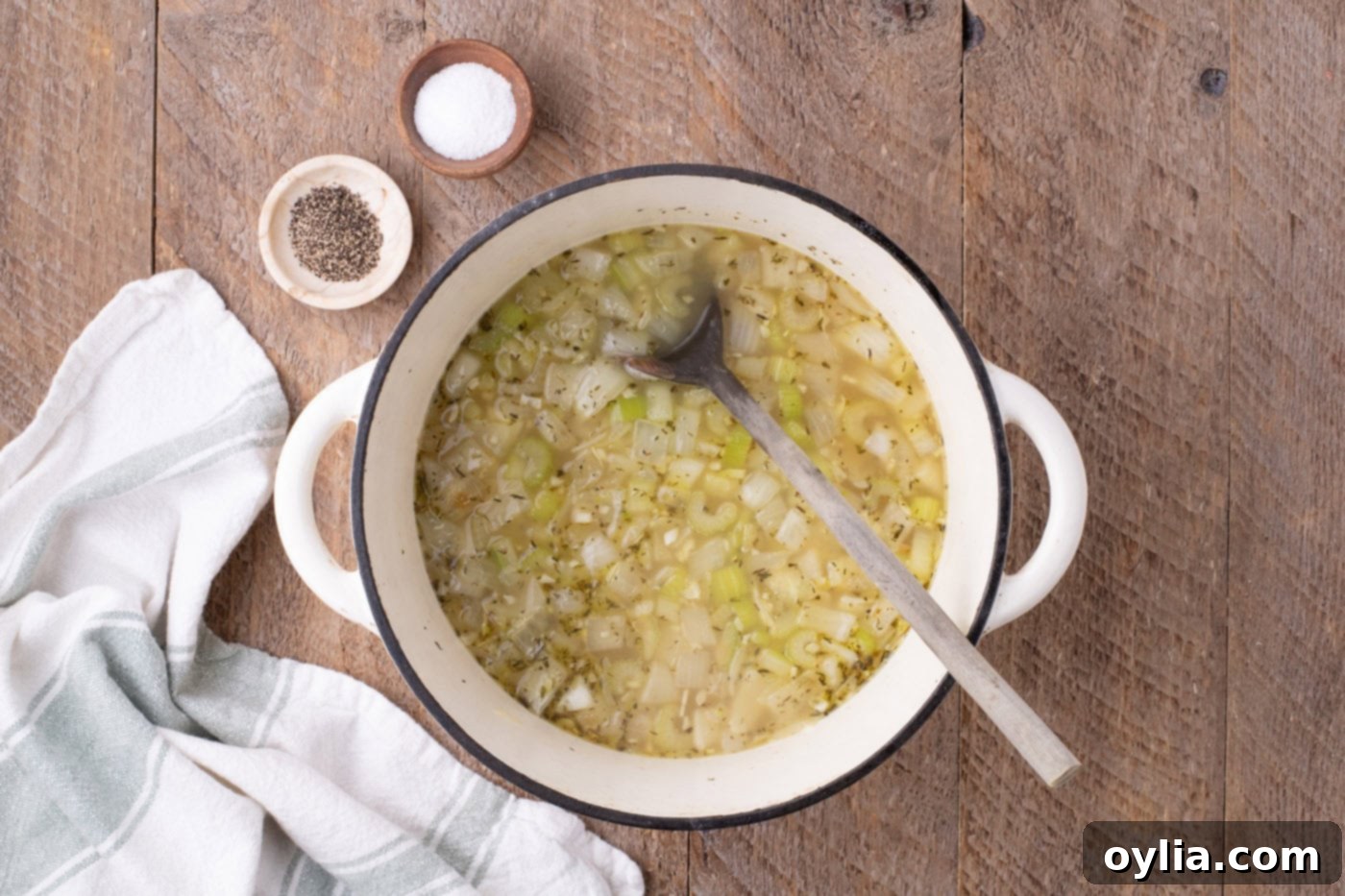 chicken stock added to sauteed veggies in a pot