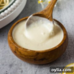 Bowl of Lemon Cream Sauce with a spoon in it
