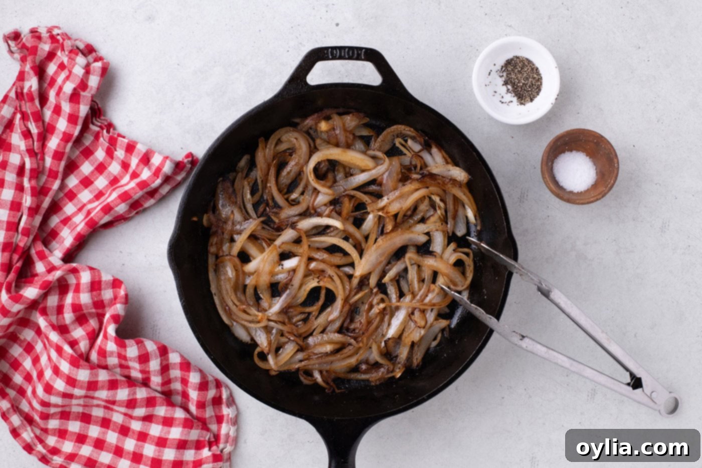 Caramelized onions cooked to a golden brown in a skillet.