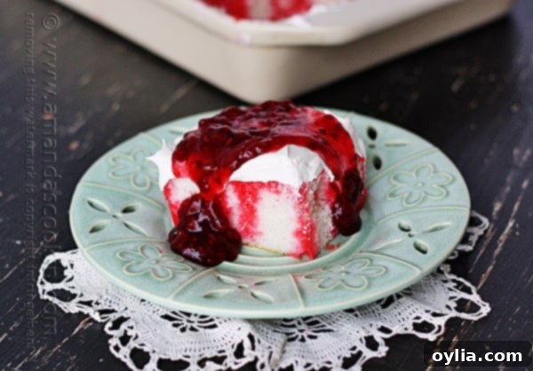 Raspberry Infusion Poke Cake 13 A vintage-style photo of a simple cake on a plate, representing the original version of the raspberry poke cake recipe.