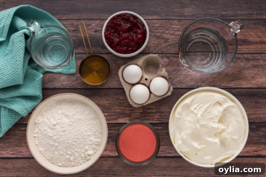 Raspberry Infusion Poke Cake 4 Collection of ingredients laid out for making Raspberry Poke Cake, including a white cake mix box, raspberry Jell-O, Cool Whip, and raspberry pie filling.