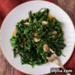Plate of Stir Fried Spinach with a fork resting to the side