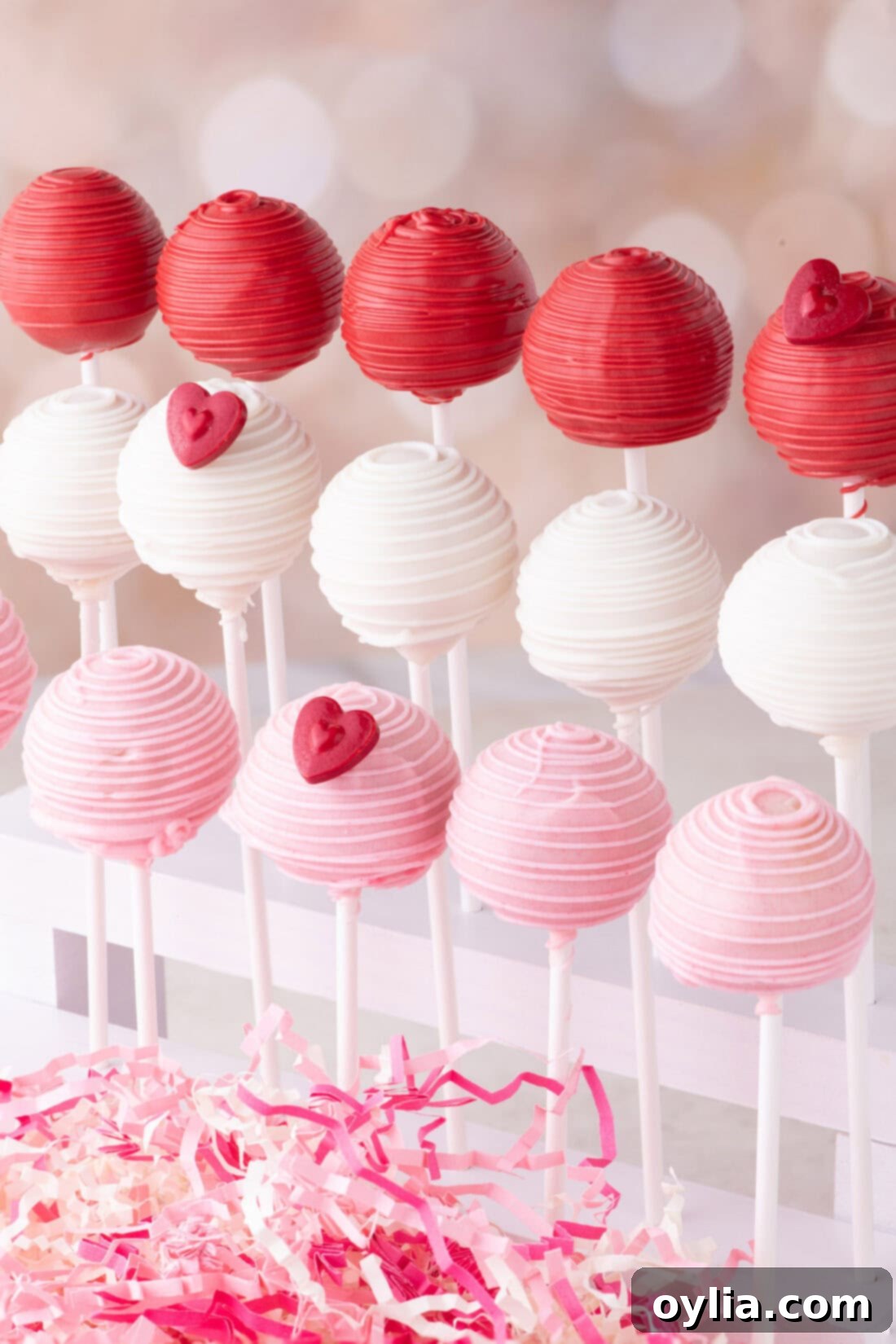 Love-Filled Valentine Cake Pops 12 A trio of perfectly decorated Valentine Cake Pops displayed on a cake pop stand, ready for a festive celebration.