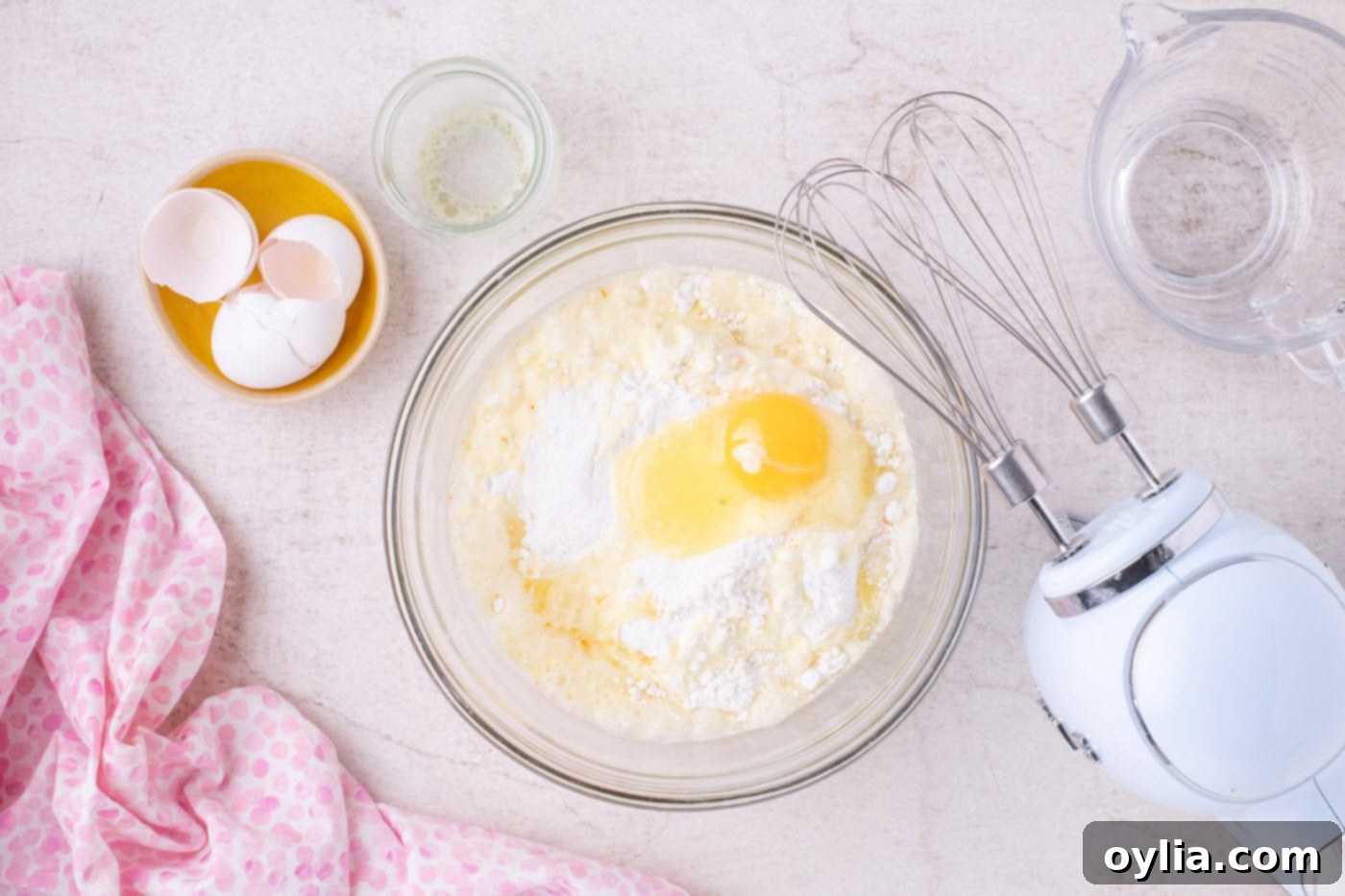 cake mix with butter, eggs, and water in a bowl being mixed