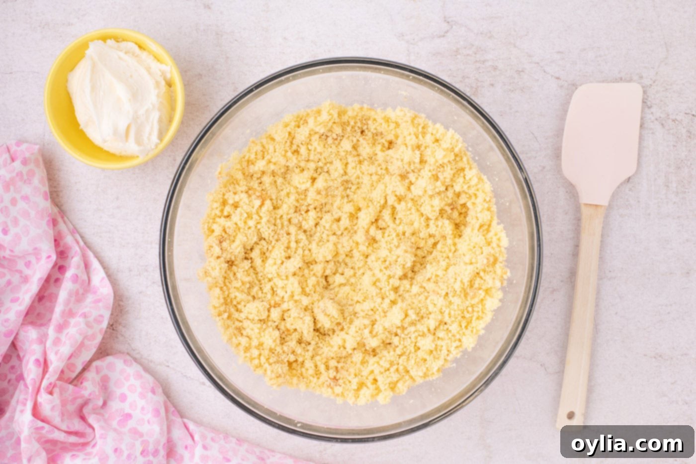 finely crumbled cake in a large mixing bowl, ready for frosting