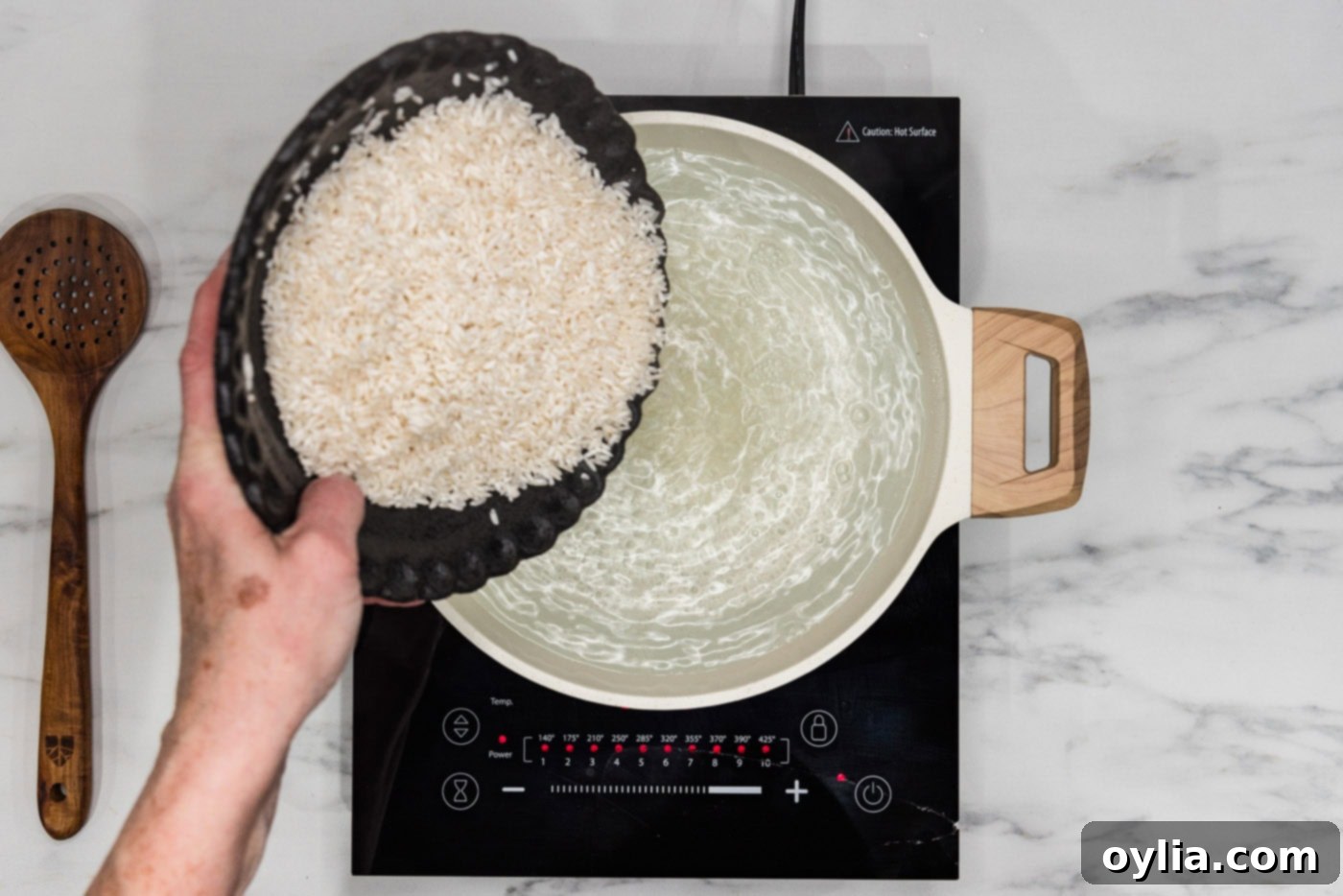 Pasta-Boiled Rice 5 Pouring rinsed rice into boiling water in a large pot
