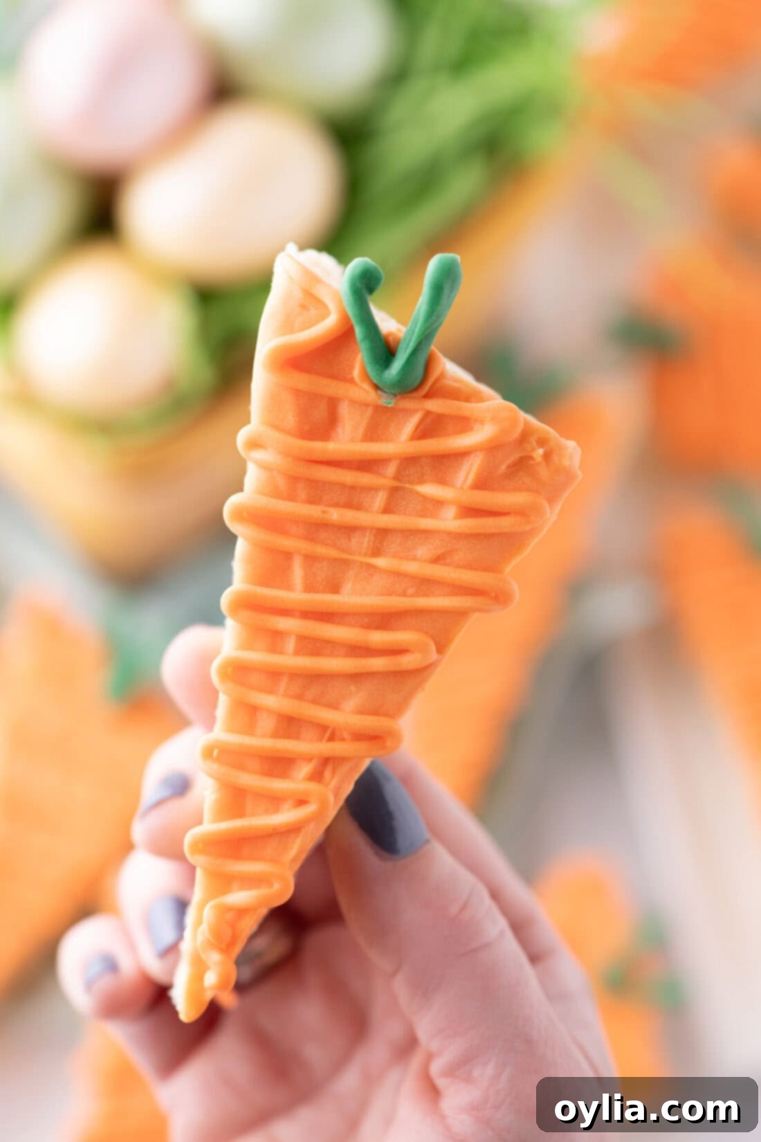 Hand holding up a Carrot Rice Krispy Treat