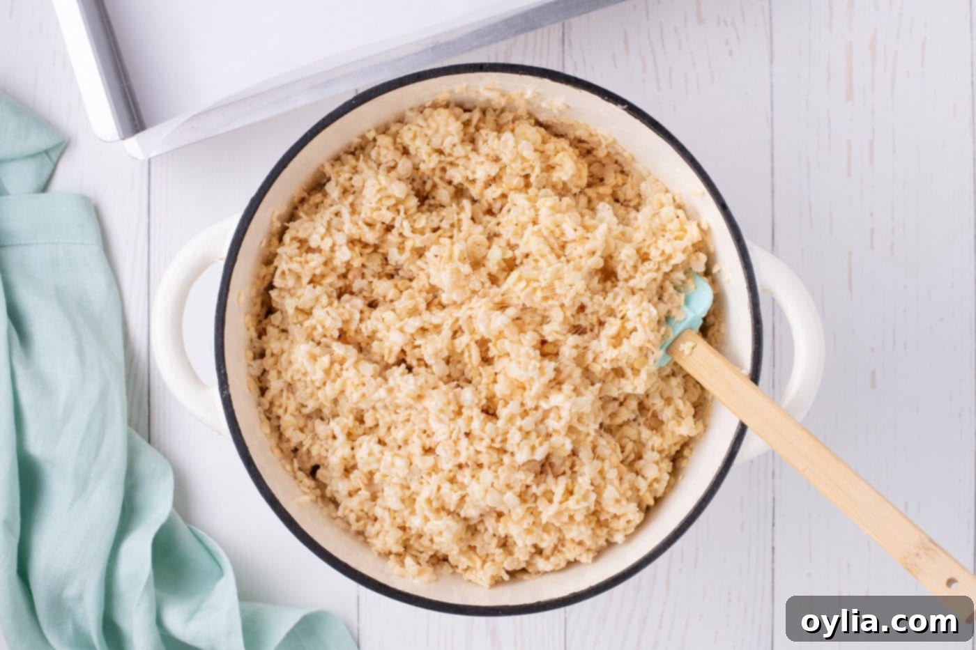 mixing melted marshmallows with rice krispie cereal
