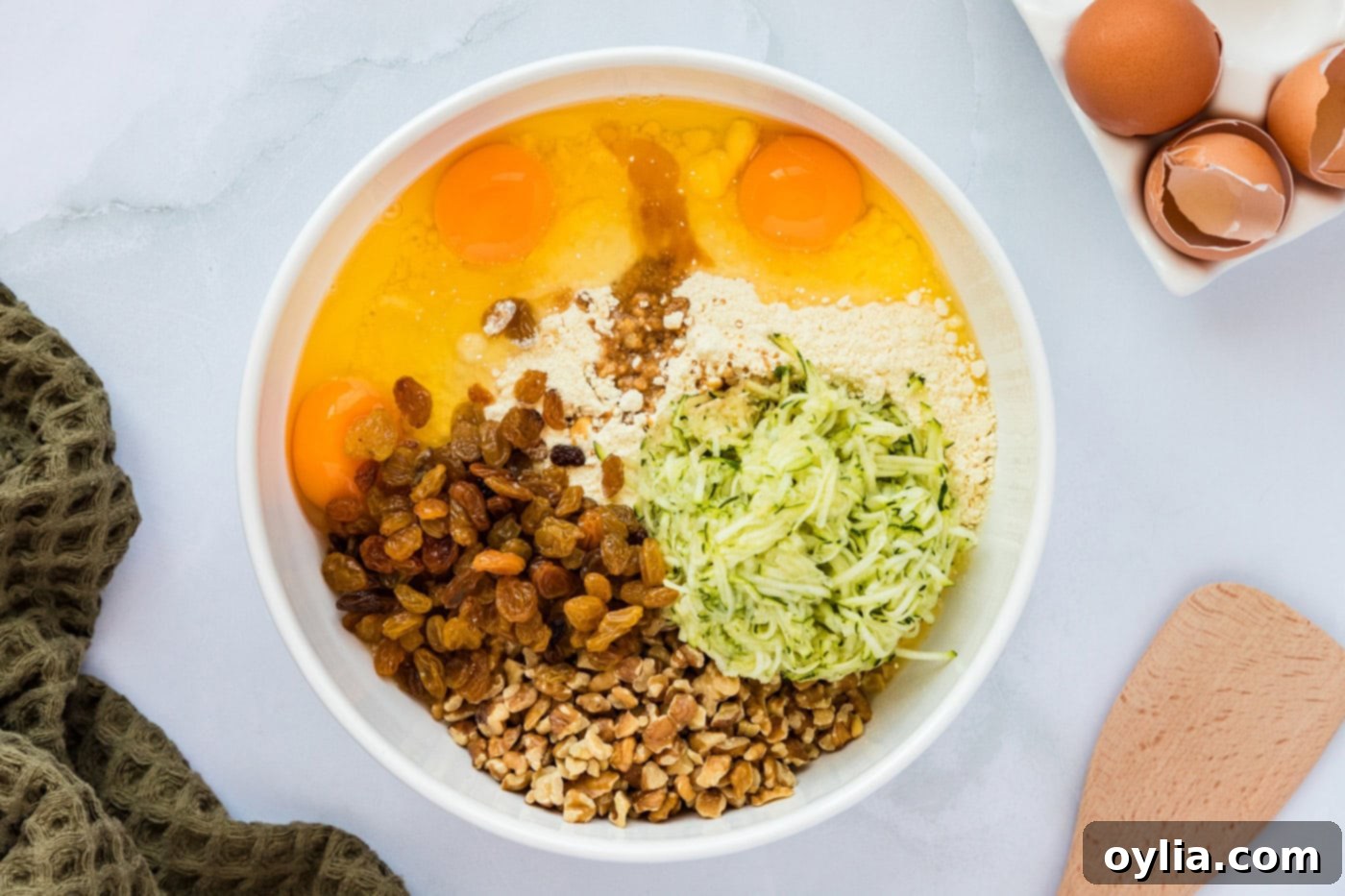 All ingredients for zucchini muffins combined in a mixing bowl